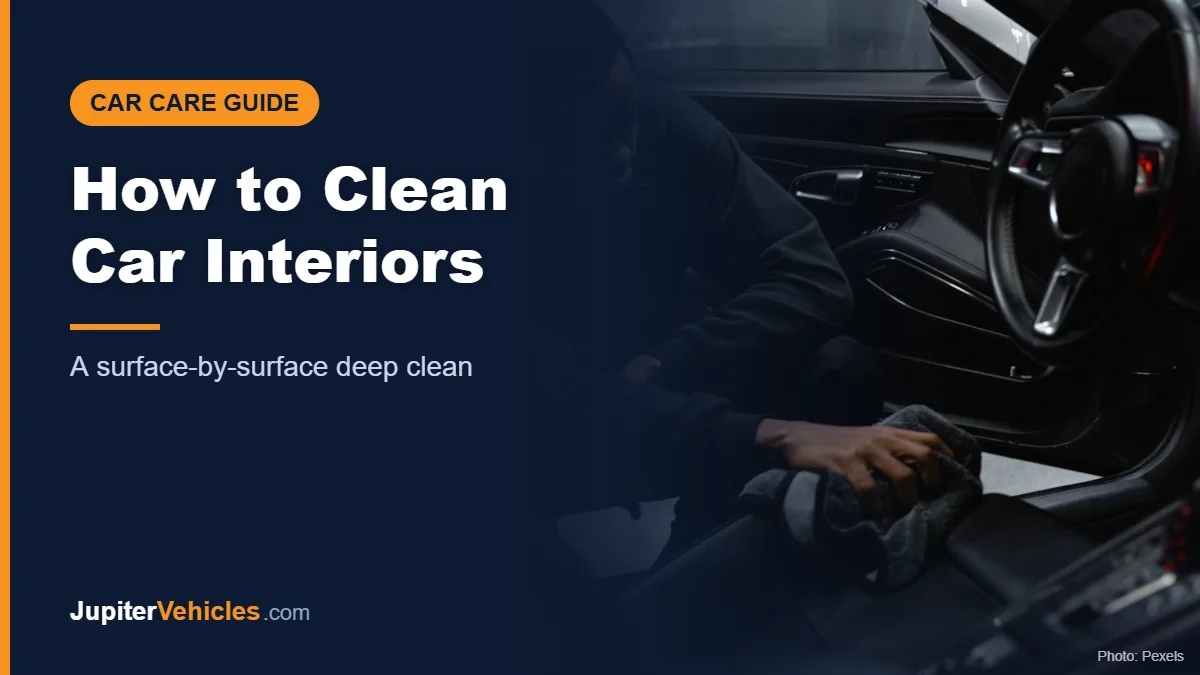 Man wiping down a car interior with a cloth during a deep clean
