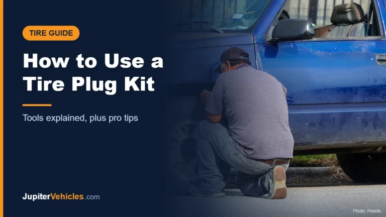 Man repairing a flat tire on a truck