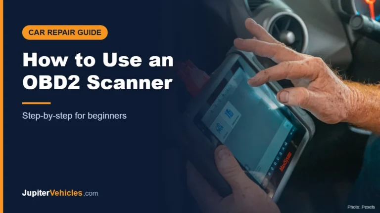 Mechanic using a diagnostic tool inside a car