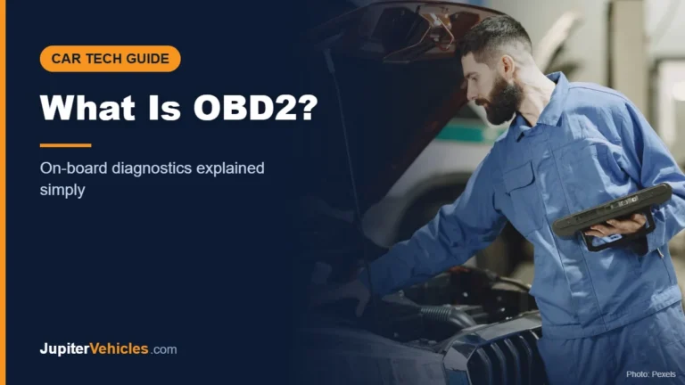 Mechanic examining a car engine under an open hood