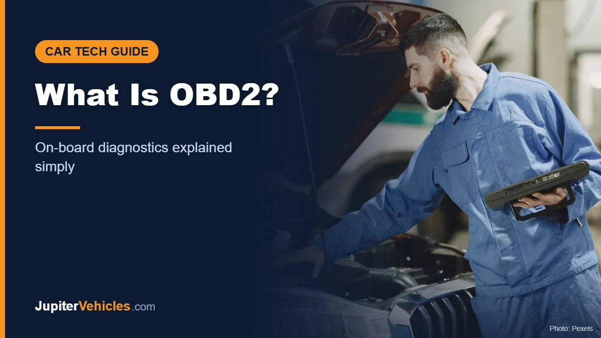 Mechanic examining a car engine under an open hood