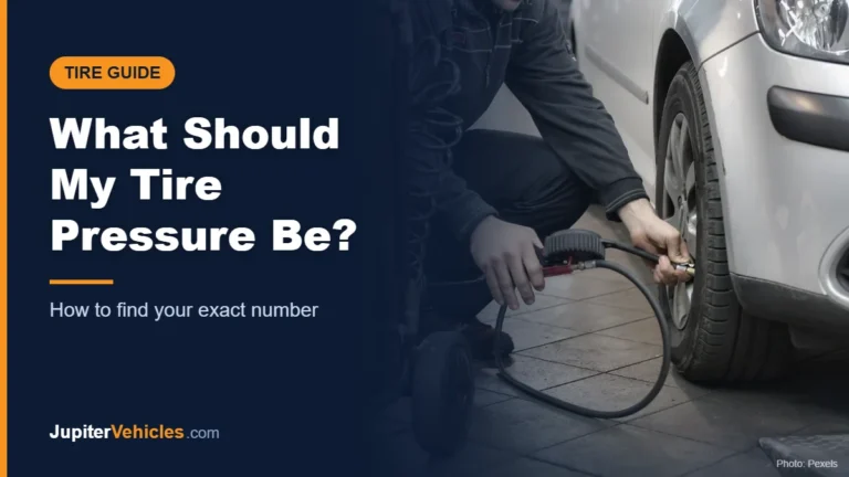 Mechanic checking and adjusting a car tire pressure